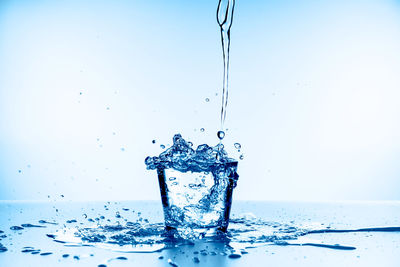 Close-up of splashing water against white background