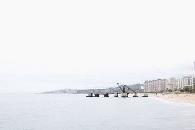 Scenic view of beach against sky in city