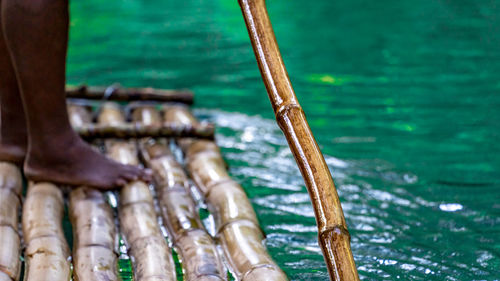 Punting down a river on a bamboo raft