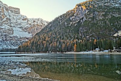 Scenic view of lake by snowcapped mountains during winter