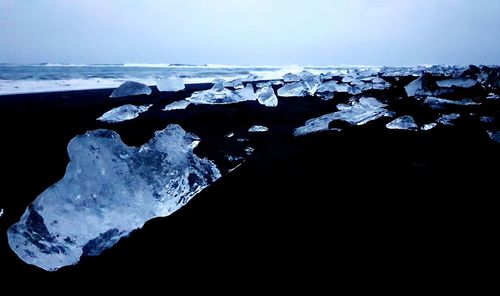 Frozen lake against sky during winter