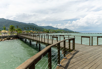 Pier over lake against sky