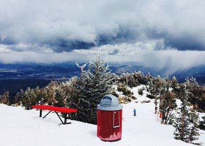 Snow covered trees and mountains against sky, top of ski slope