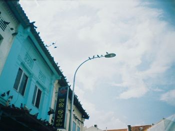 Low angle view of building against cloudy sky