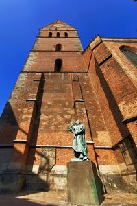 Low angle view of statue against sky