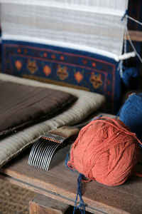 Close-up of weaving frame and yarn against white background