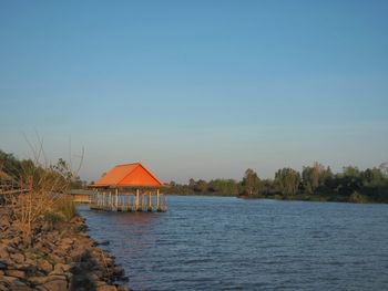 Scenic view of lake against clear blue sky