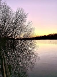 Scenic view of lake against sky at sunset