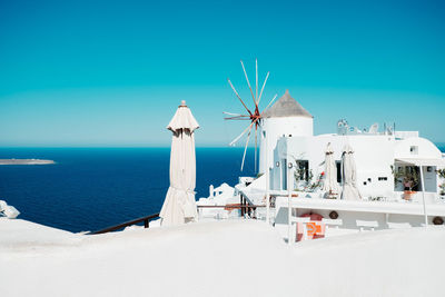 Built structure on beach against clear blue sky