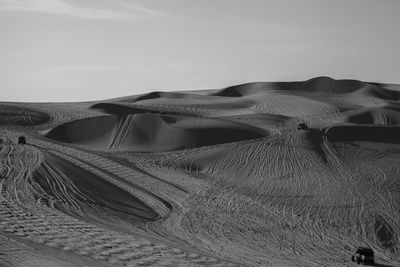 Sand dune in desert against sky
