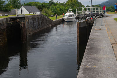 Bridge over river by buildings