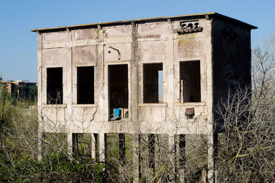 Old abandoned building against clear sky
