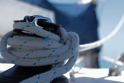 Close-up of rope tied to boat moored at harbor