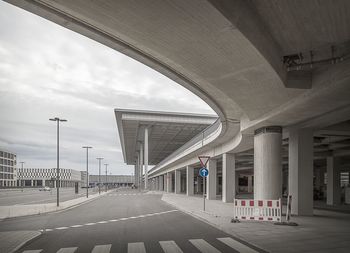 Empty road against sky in city