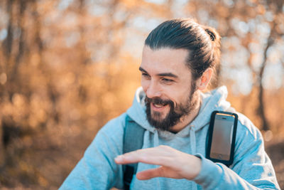Portrait of man using mobile phone outdoors