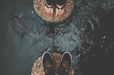 Low section of person standing in water