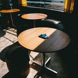 High angle view of mobile phones on table at restaurant