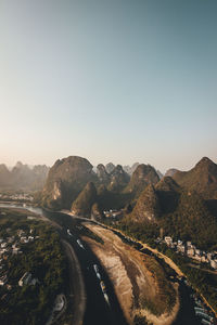 Road by mountains against clear sky