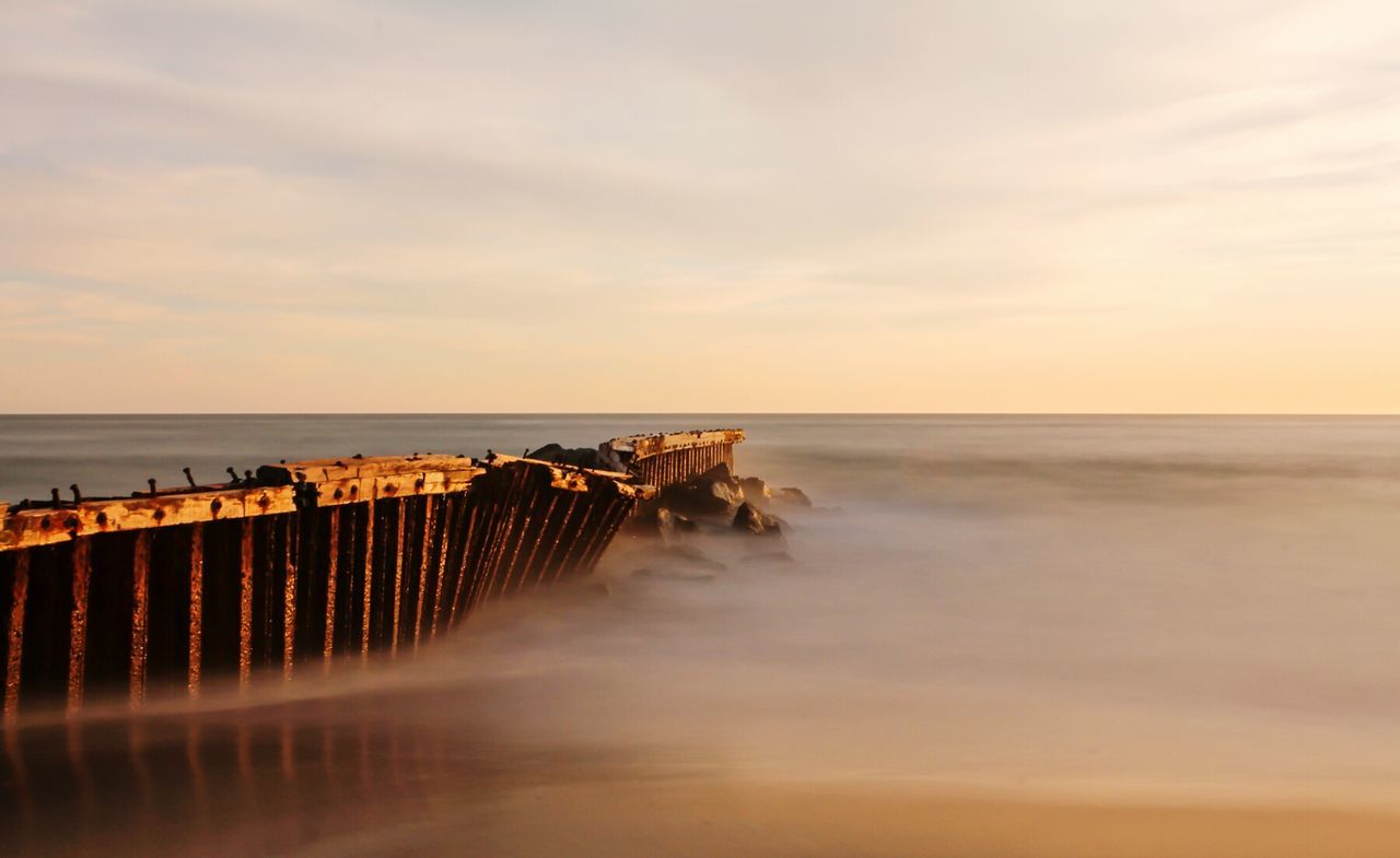 sea, water, horizon over water, sky, pier, scenics, sunset, tranquil scene, cloud - sky, tranquility, beach, beauty in nature, nature, built structure, waterfront, idyllic, architecture, shore, dusk, cloudy