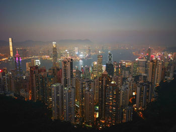 Illuminated cityscape against sky at night