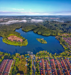 High angle view of trees on landscape against cloudy sky