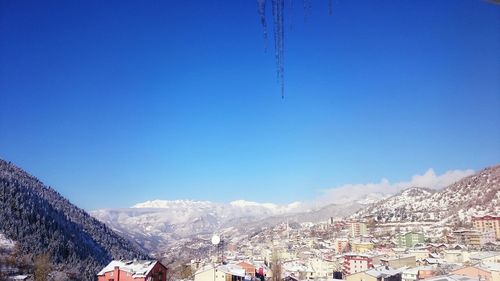 Scenic shot of snowcapped mountains against blue sky