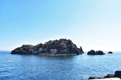 Scenic view of sea against clear blue sky