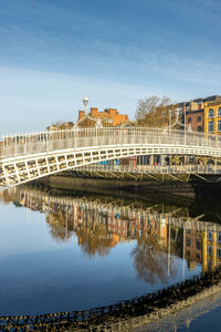 Bridge over river against buildings