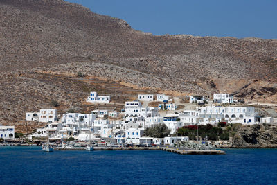 High angle view of townscape by sea against clear sky