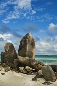 Rocks on beach against sky