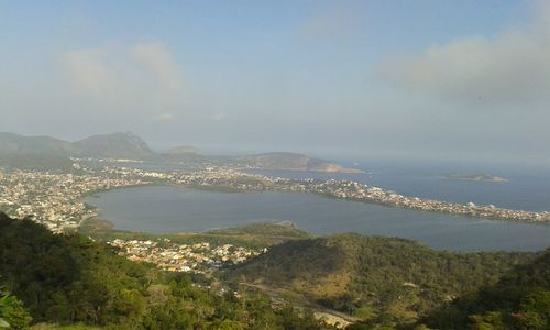 Scenic view of sea and mountains against sky