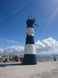 Low angle view of lighthouse on beach against sky