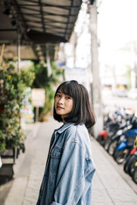 Portrait of smiling young woman standing outdoors