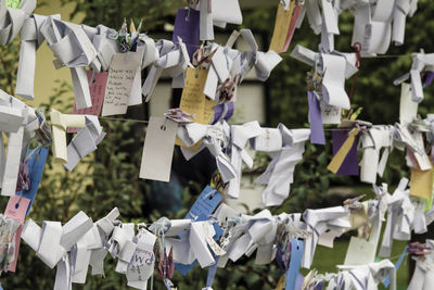 Full frame shot of papers with messages tied on ropes