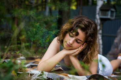 Portrait of young woman sitting on field