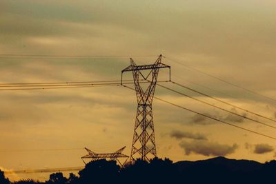 Low angle view of electricity pylon against sky