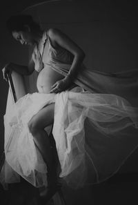 Woman sitting on bed