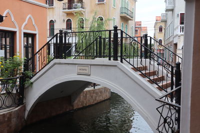 Bridge over canal amidst buildings in city