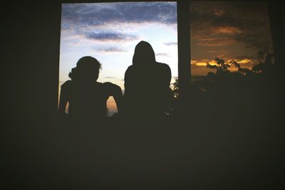 Silhouette of woman at sunset