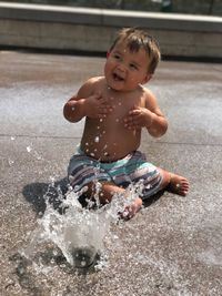 Portrait of boy playing in water