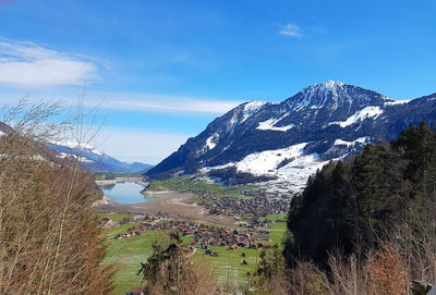 Scenic view of mountains against blue sky