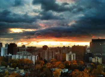 Cityscape against cloudy sky