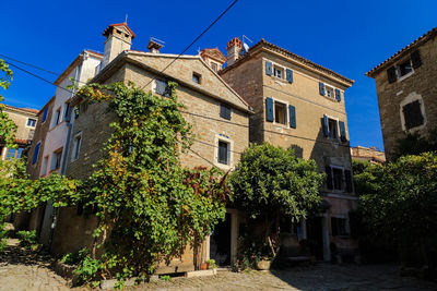 Low angle view of town against clear blue sky