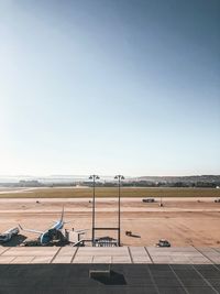 Airplane on runway against clear sky