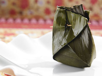 Close-up of food wrapped in banana leaf served in plate