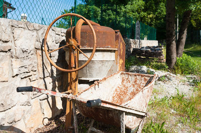 Old rusty wheel on field