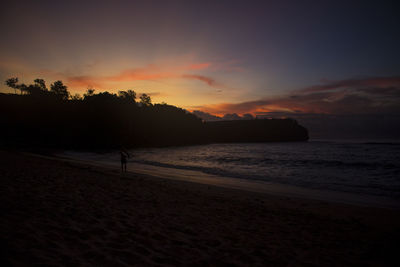 Scenic view of beach against sky during sunset