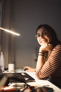 Young woman using laptop at home