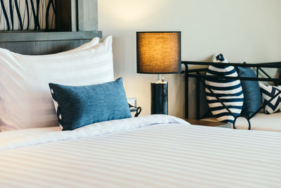 Pillows on bed in bedroom at home