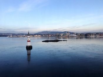 Scenic view of lake against sky during winter